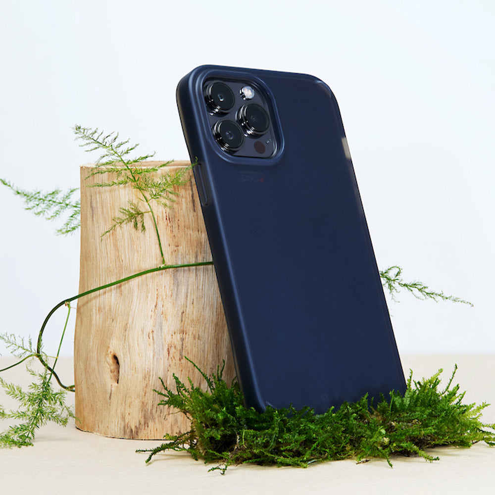 EFM Bio+ Smoke Clear Phone Case For iPhone 13 Pro Max (6.7") leaning on wood with leaves